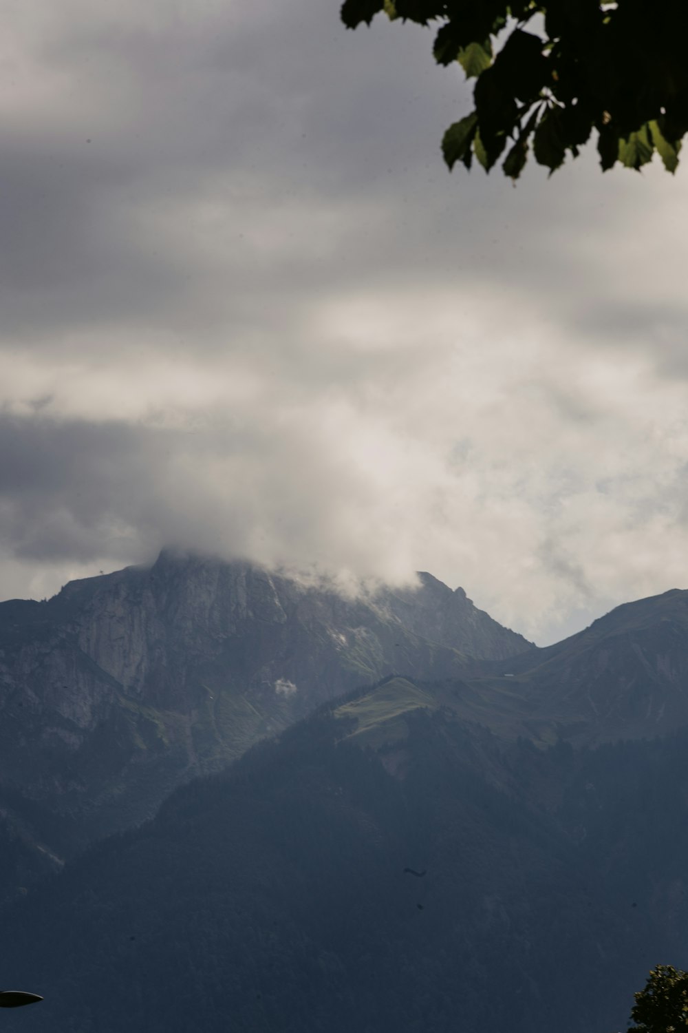 a view of a mountain range with clouds in the sky