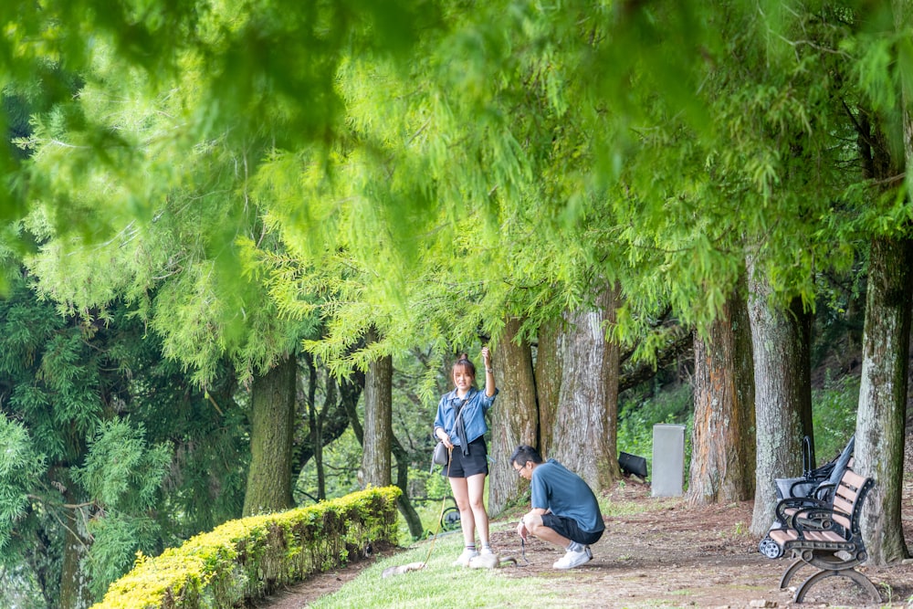 a couple of people that are standing in the grass