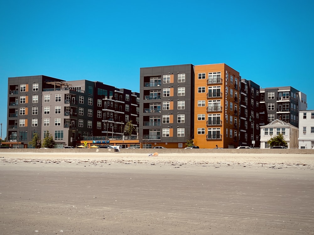 a row of multi - story apartment buildings on a beach