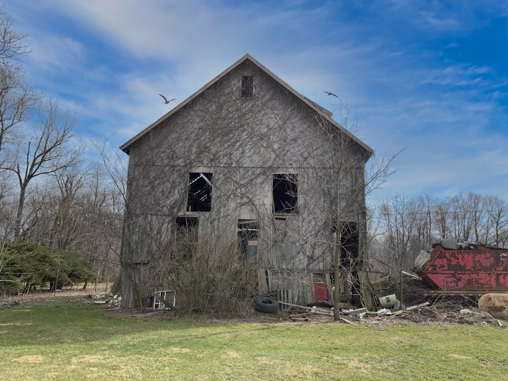 a run down building with broken windows and graffiti on it