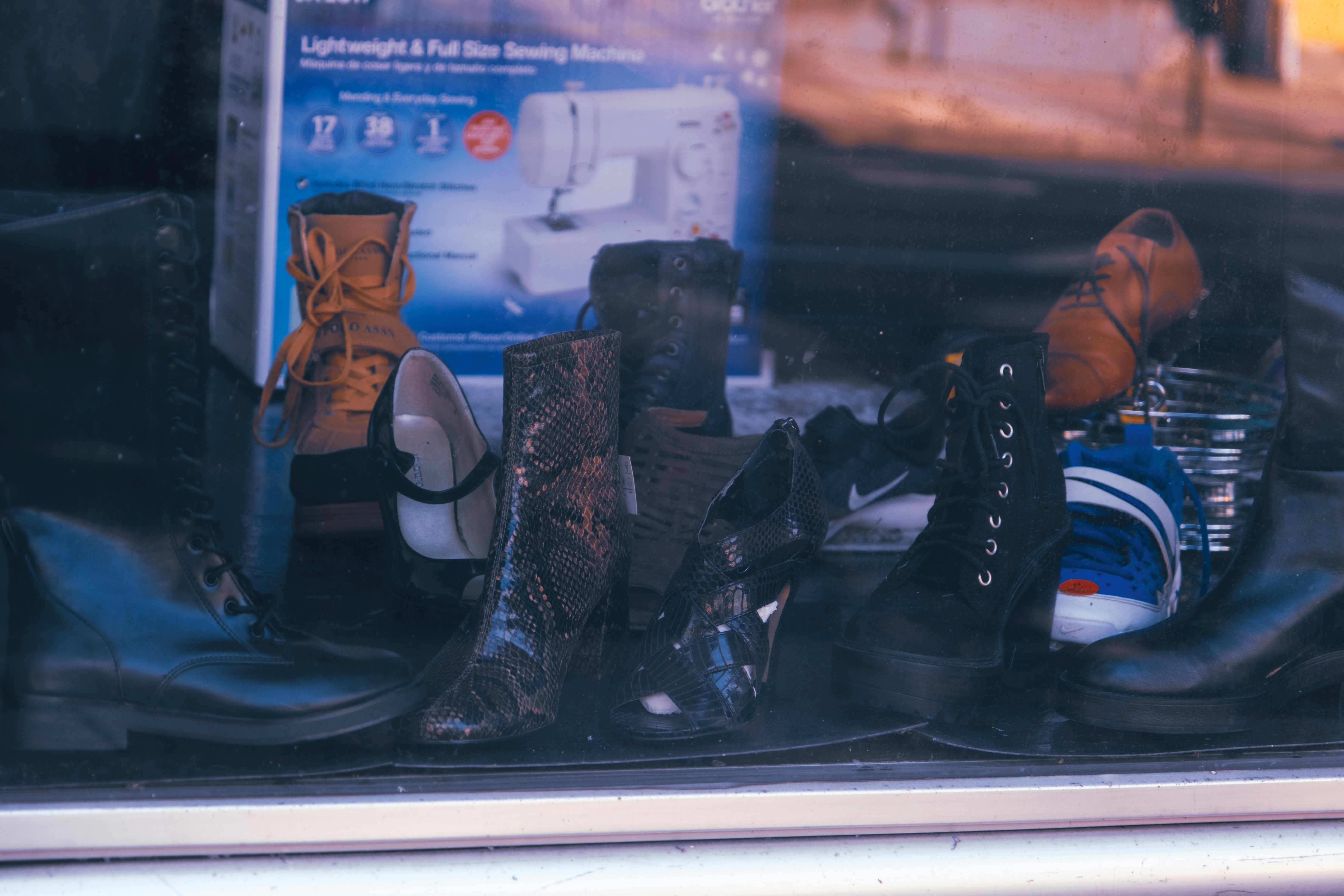 a bunch of shoes that are sitting in a window