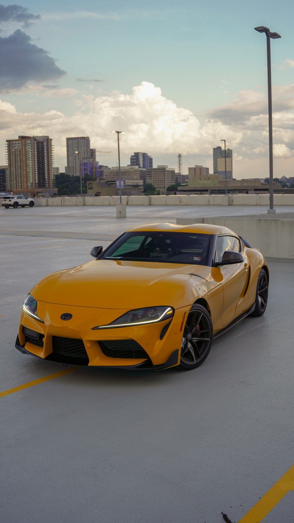 a yellow sports car parked in a parking lot