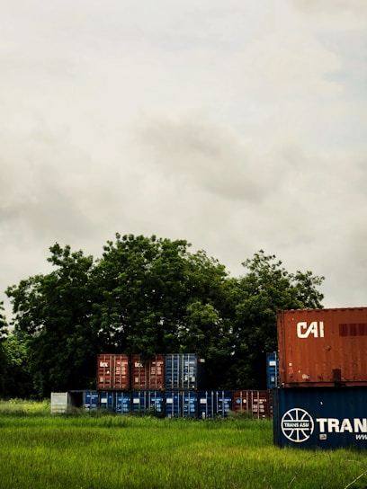 A subtle transparent overlay on a video background showing farmers and secure shipping containers.