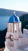 a white and blue church with a bell tower