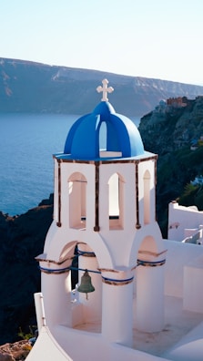 a white and blue church with a bell tower