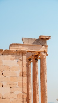 a tall stone building with two large pillars