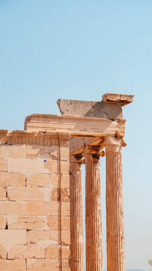 a tall stone building with two large pillars