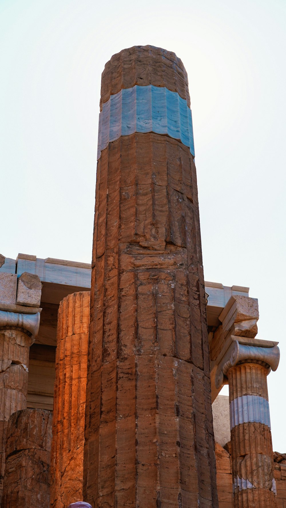 a tall brick structure with blue and white stripes on it