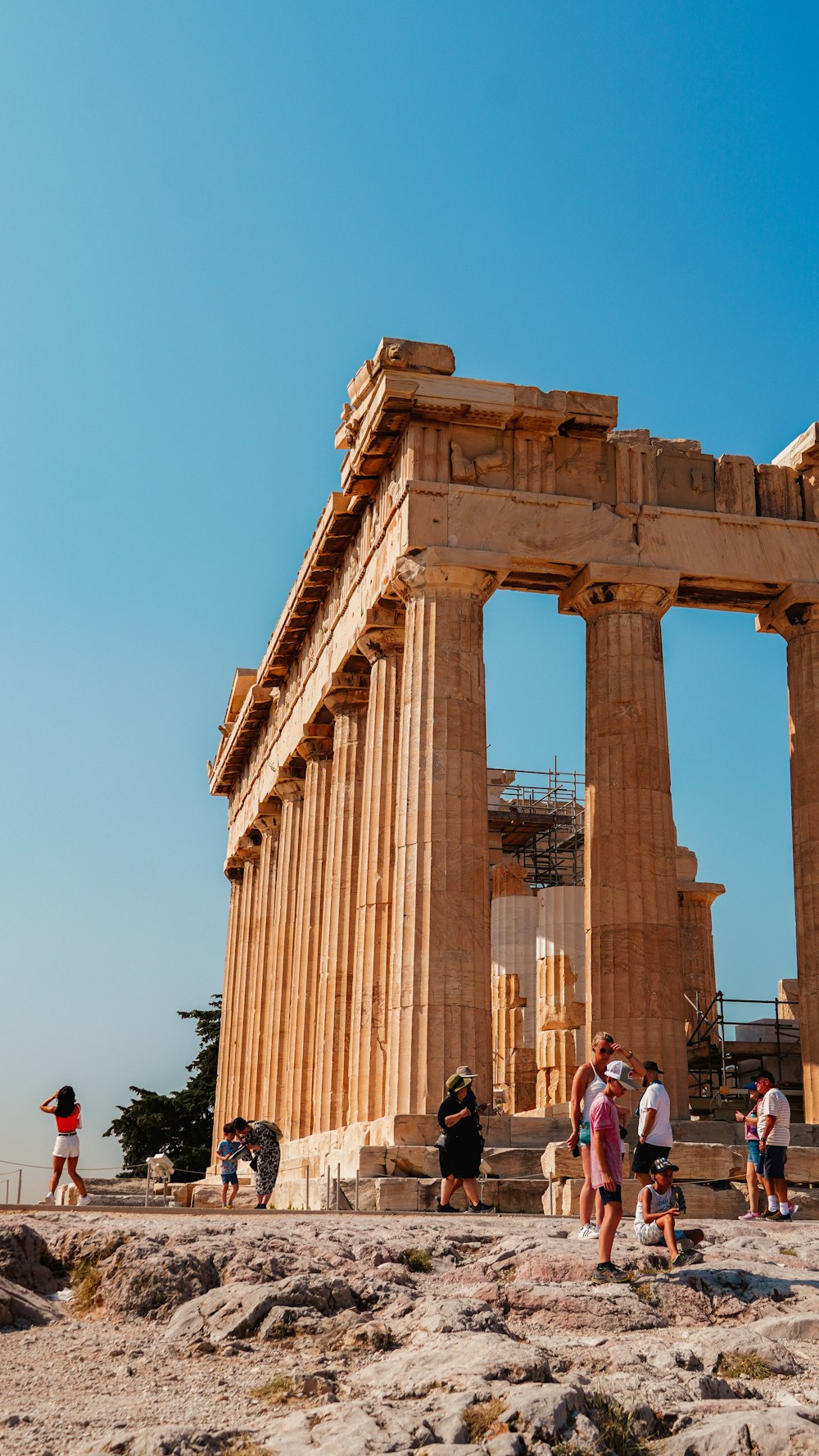 a group of people standing in front of an ancient structure