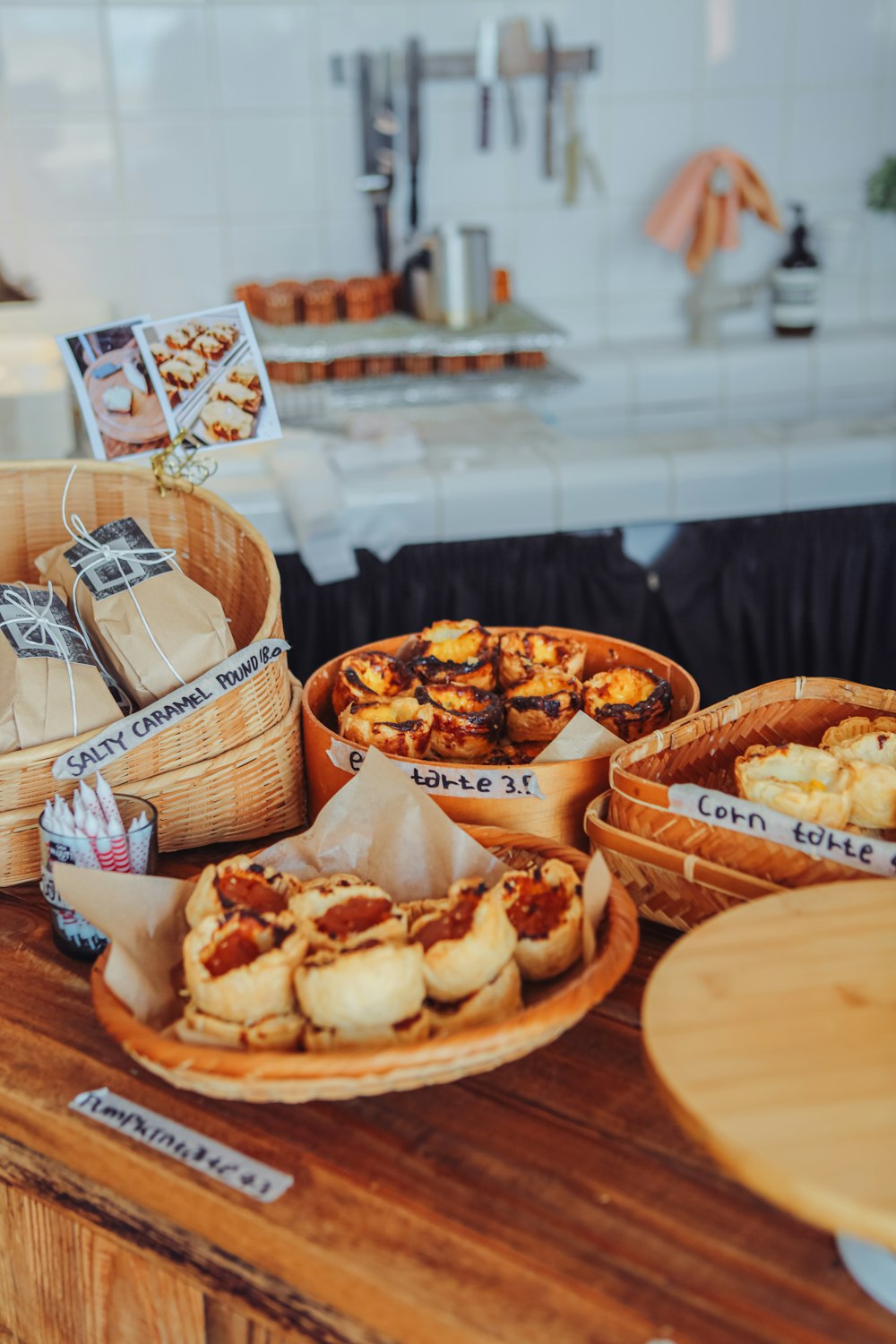 a wooden table topped with baskets filled with food