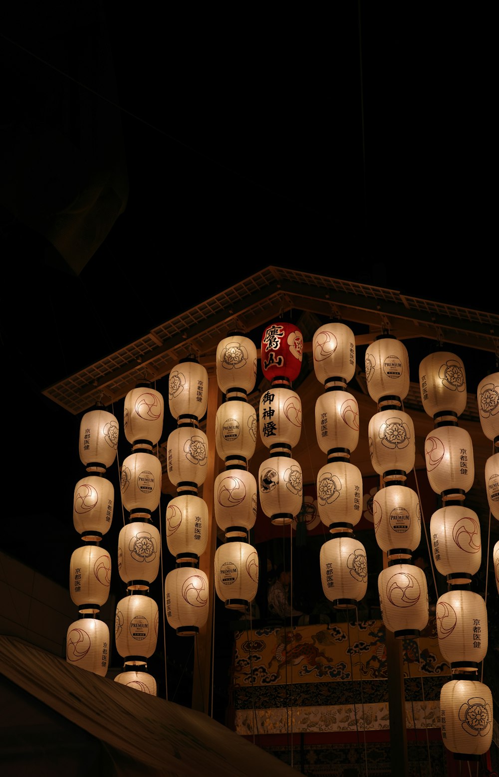 a number of paper lanterns hanging from a roof