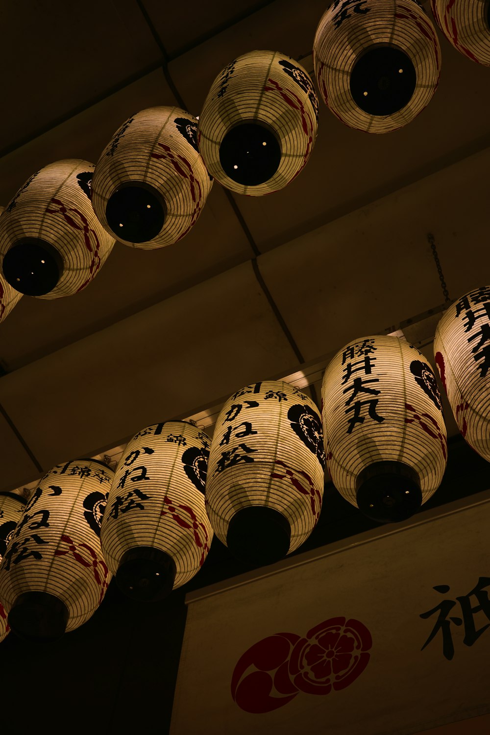 a group of paper lanterns hanging from a ceiling