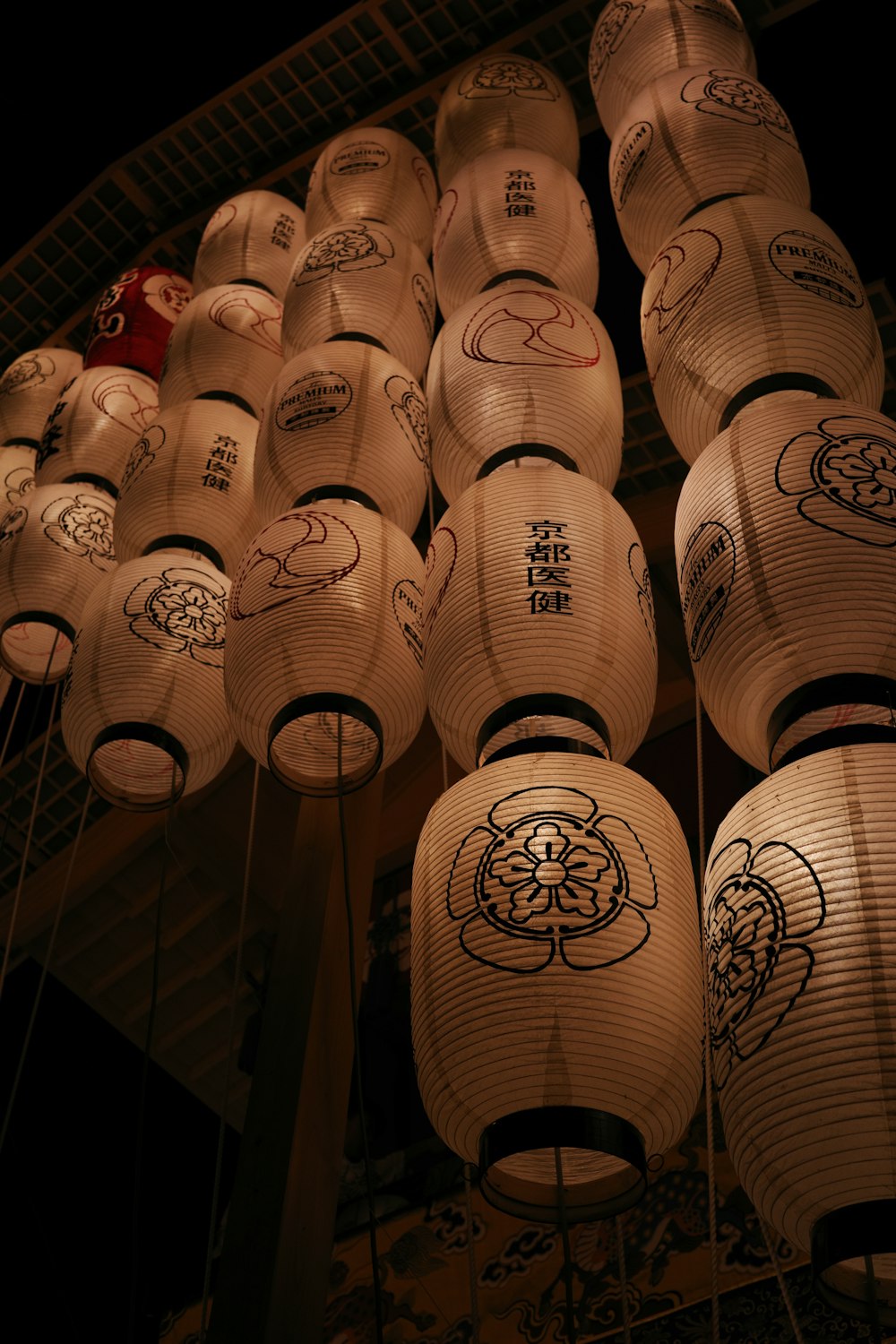 a bunch of paper lanterns hanging from a ceiling