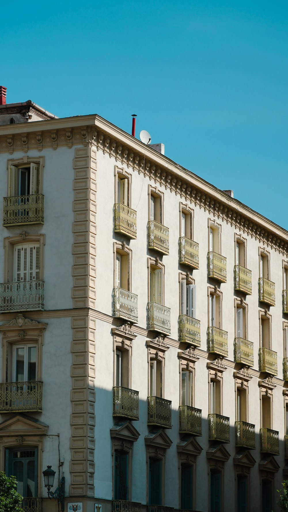 a tall white building with balconies and balconies