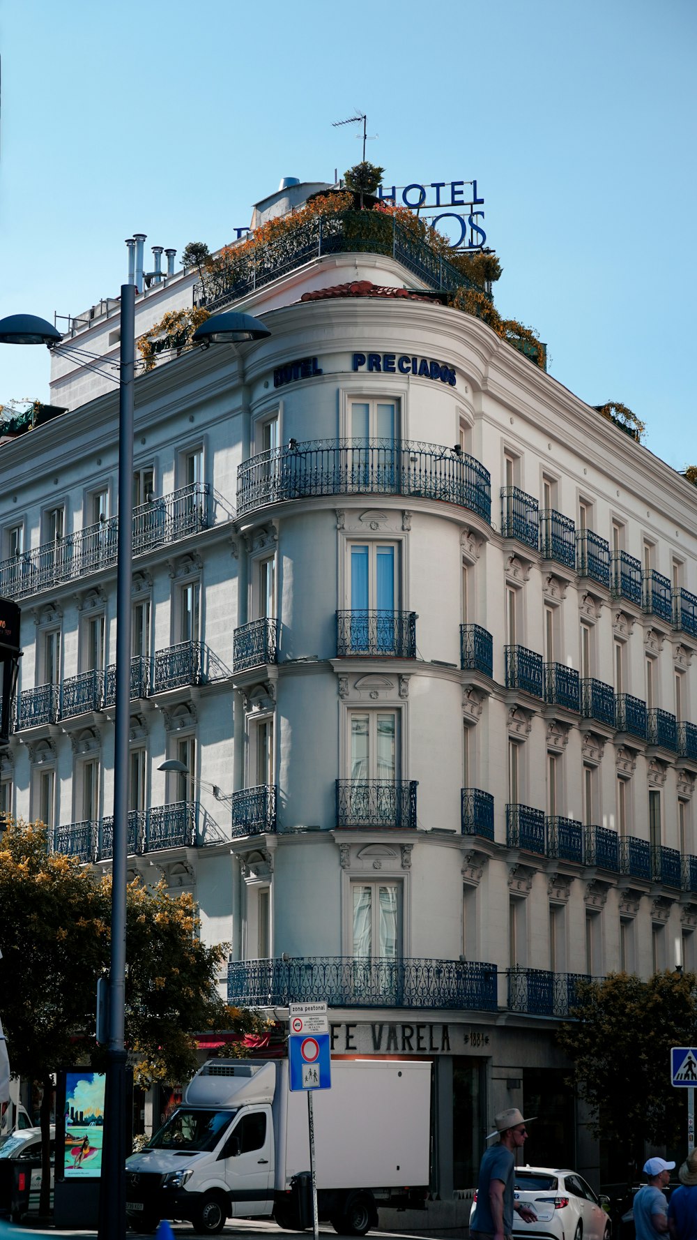 a tall white building with balconies and balconies on top