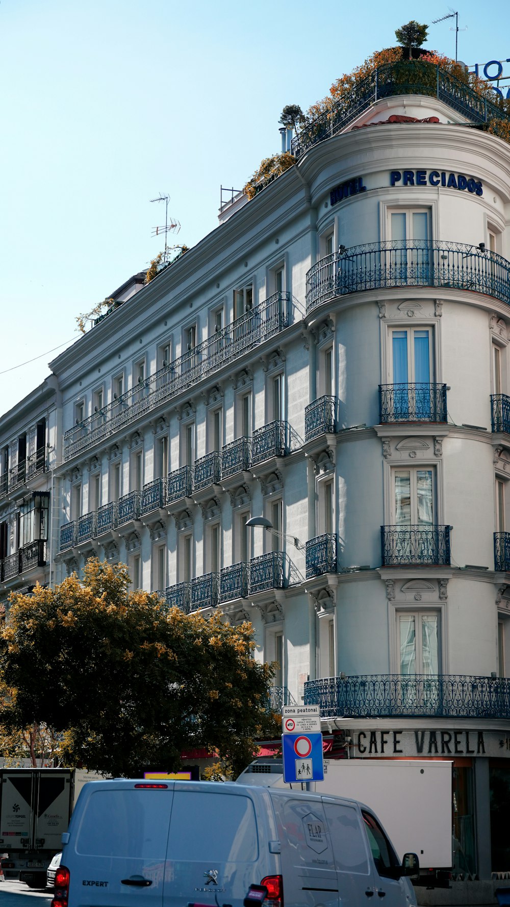 a white building with balconies and balconies on top