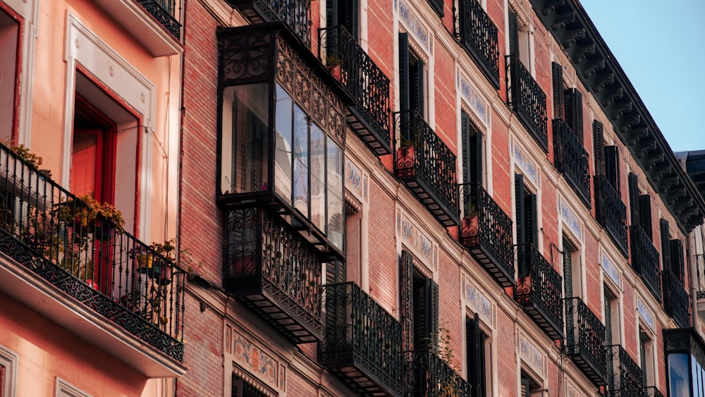 a building with balconies and a clock on the side of it