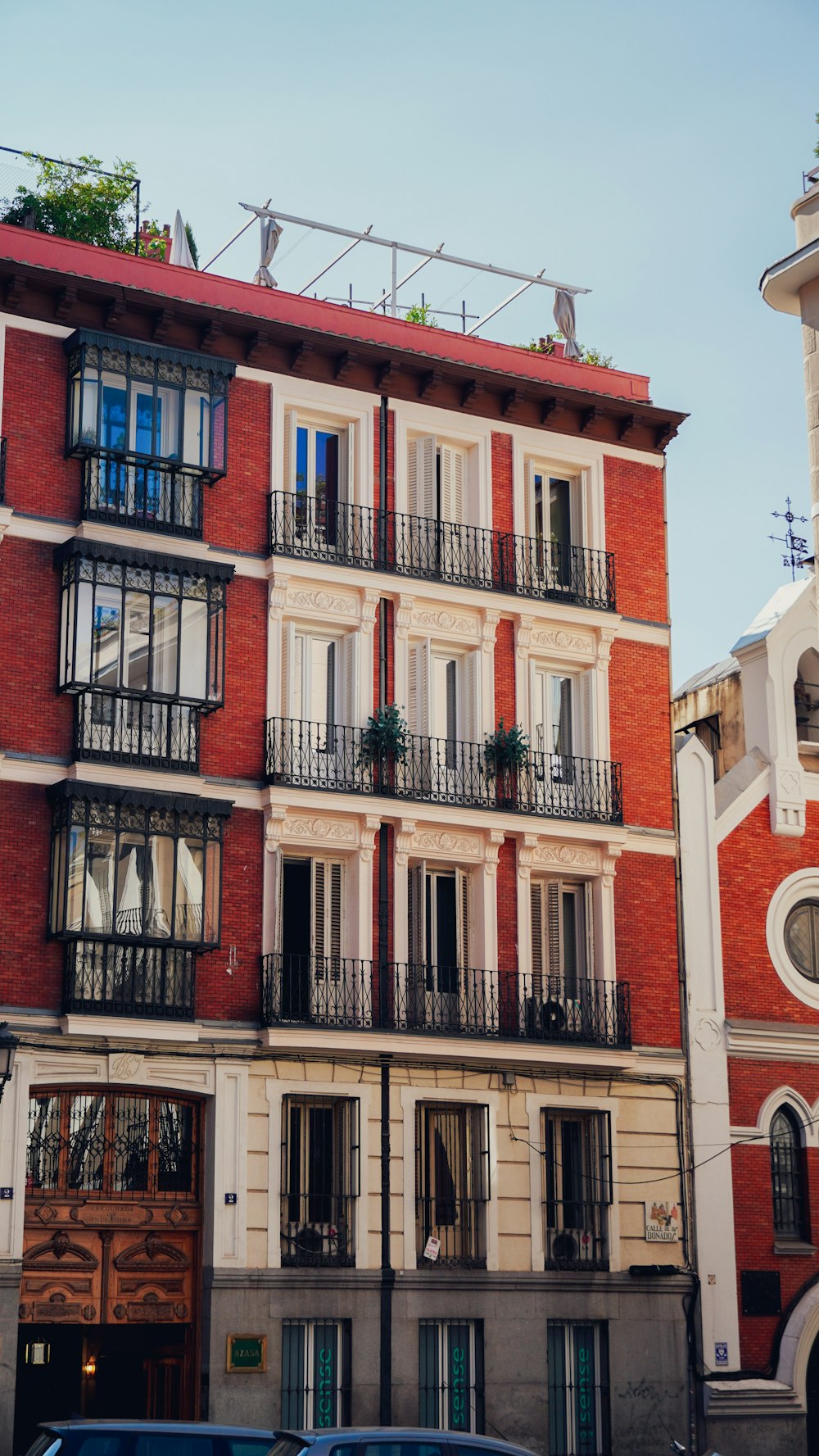 a tall red brick building with balconies and balconies