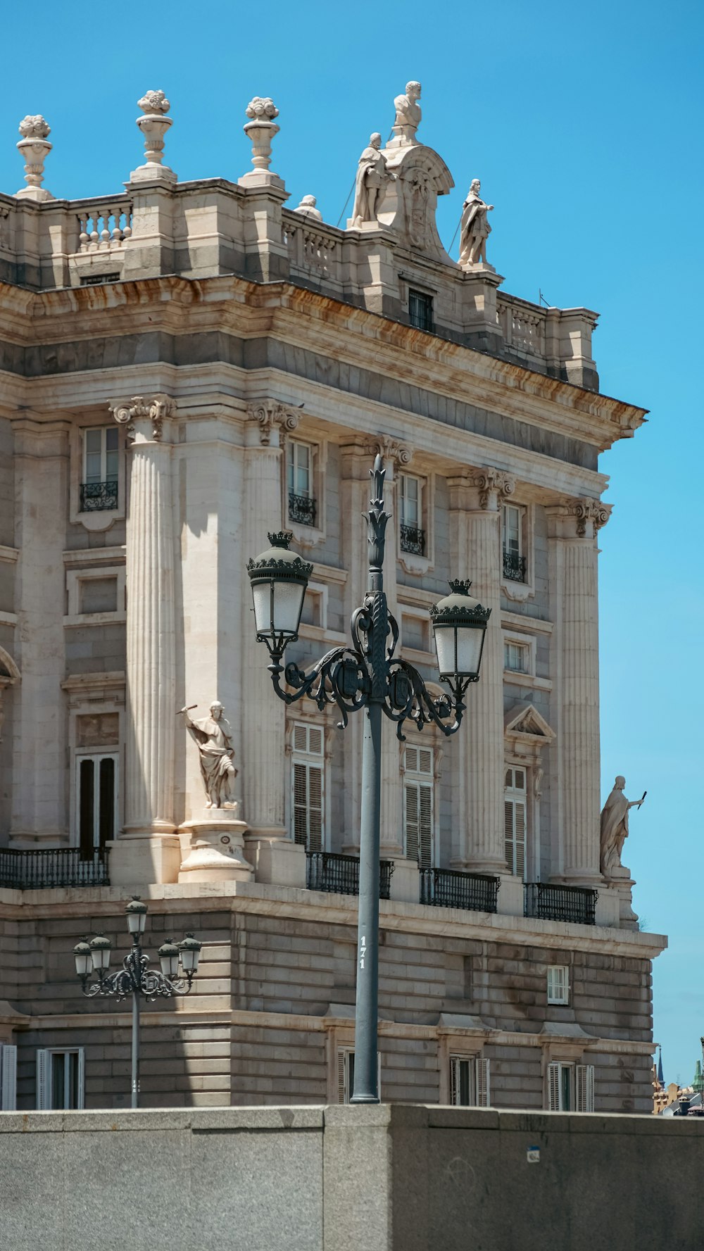 a tall building with statues on top of it