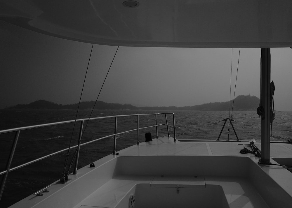 a black and white photo of a boat in the ocean