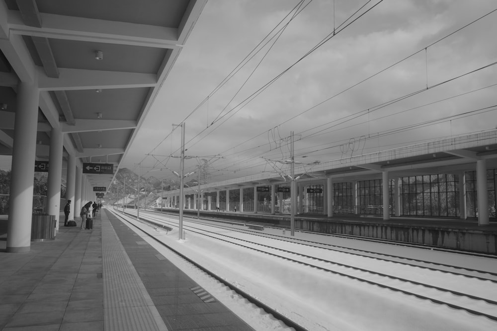 a black and white photo of a train station