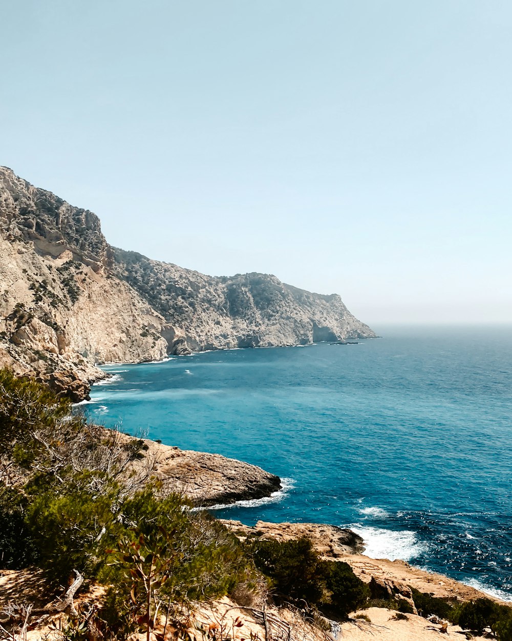 a view of the ocean from a rocky cliff