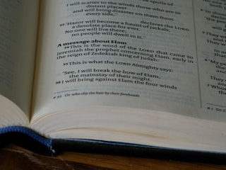 A close-up of a leather-bound heirloom book open to a beautifully typeset memoir page.
