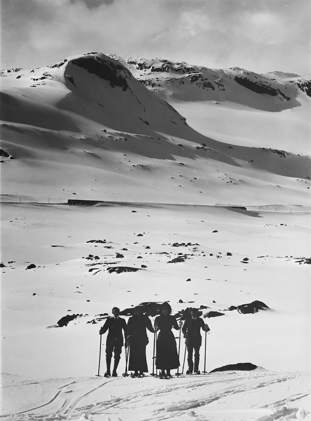 a group of people standing on top of a snow covered slope