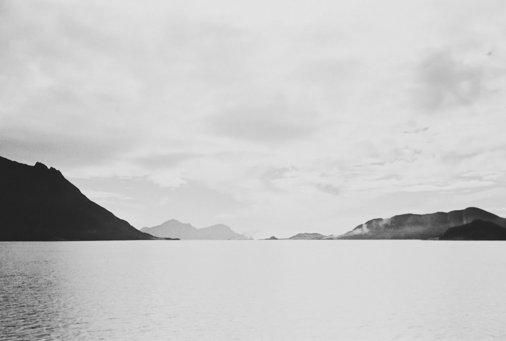 a large body of water with mountains in the background