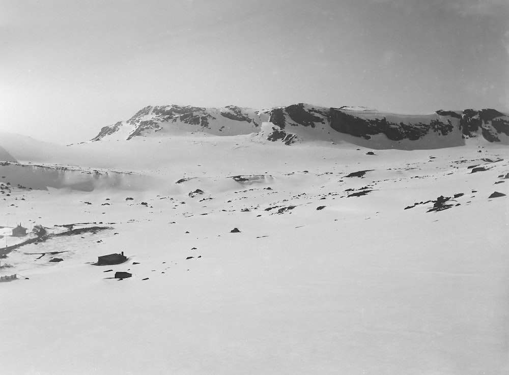 a black and white photo of a snow covered mountain