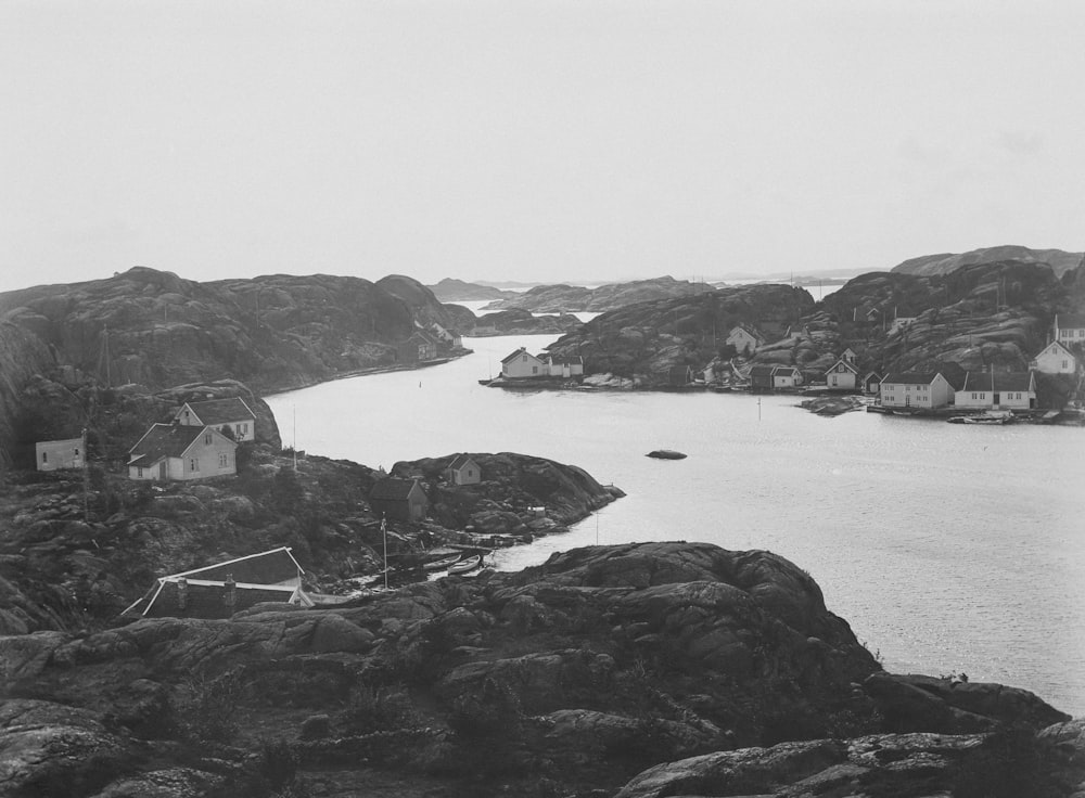 a black and white photo of a harbor with houses