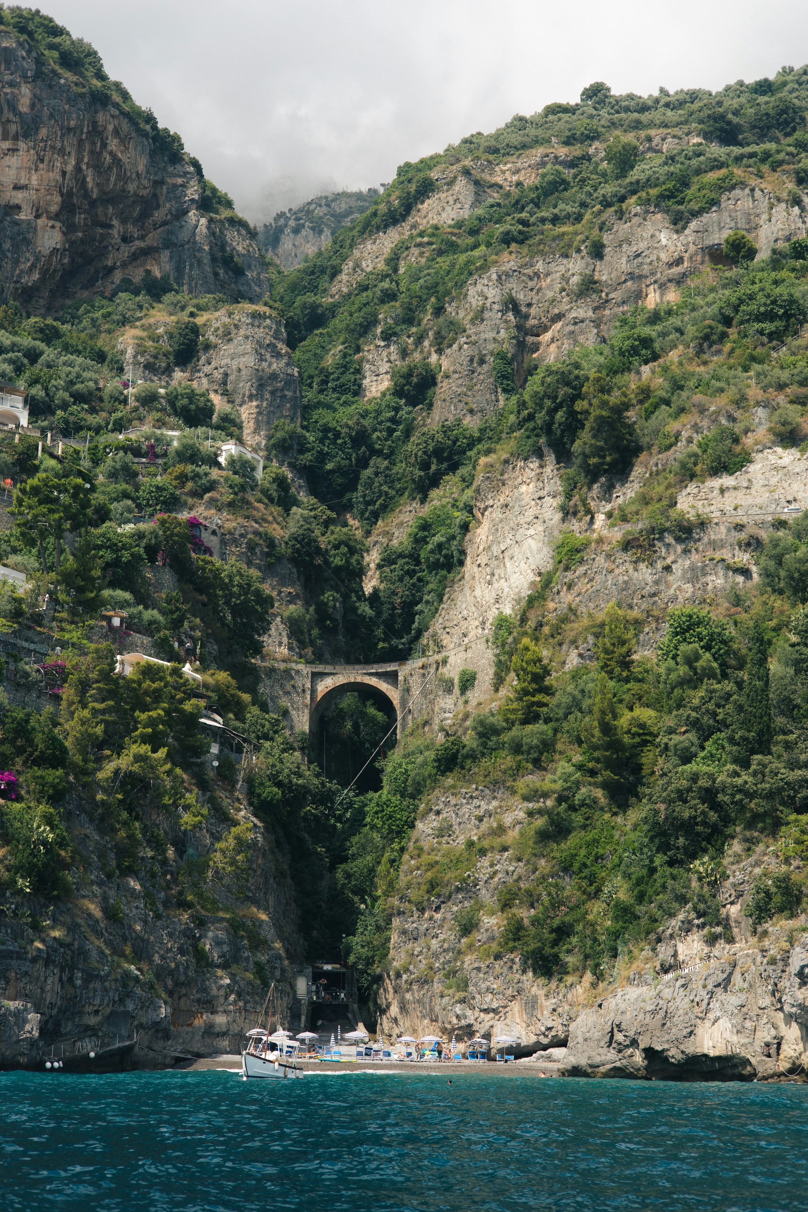 a bridge over a body of water near a mountain