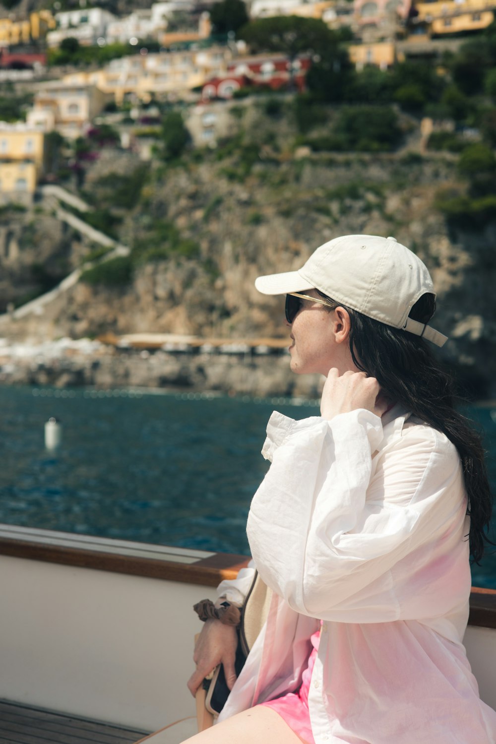 a woman sitting on a boat looking out at the water