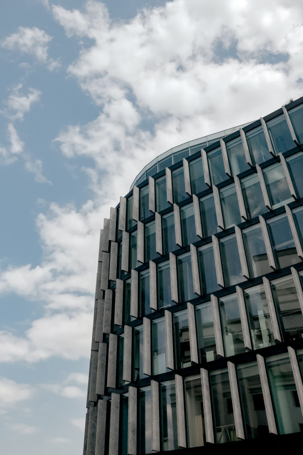 a tall building with many windows and a sky background