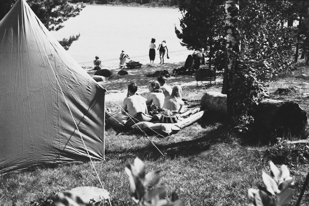 a group of people sitting around a tent