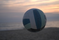 Close-up of a polished volleyball spinning through the air, the colors vibrant against the sky.