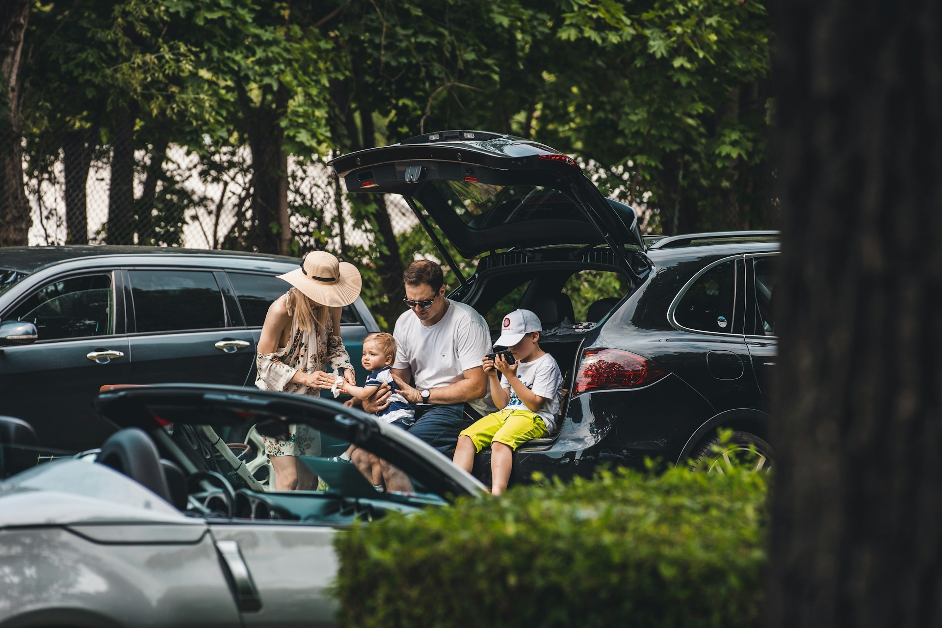 a group of people sitting in the trunk of a car
