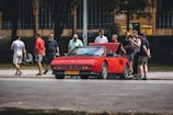 A group of car enthusiasts admiring a rare vehicle.