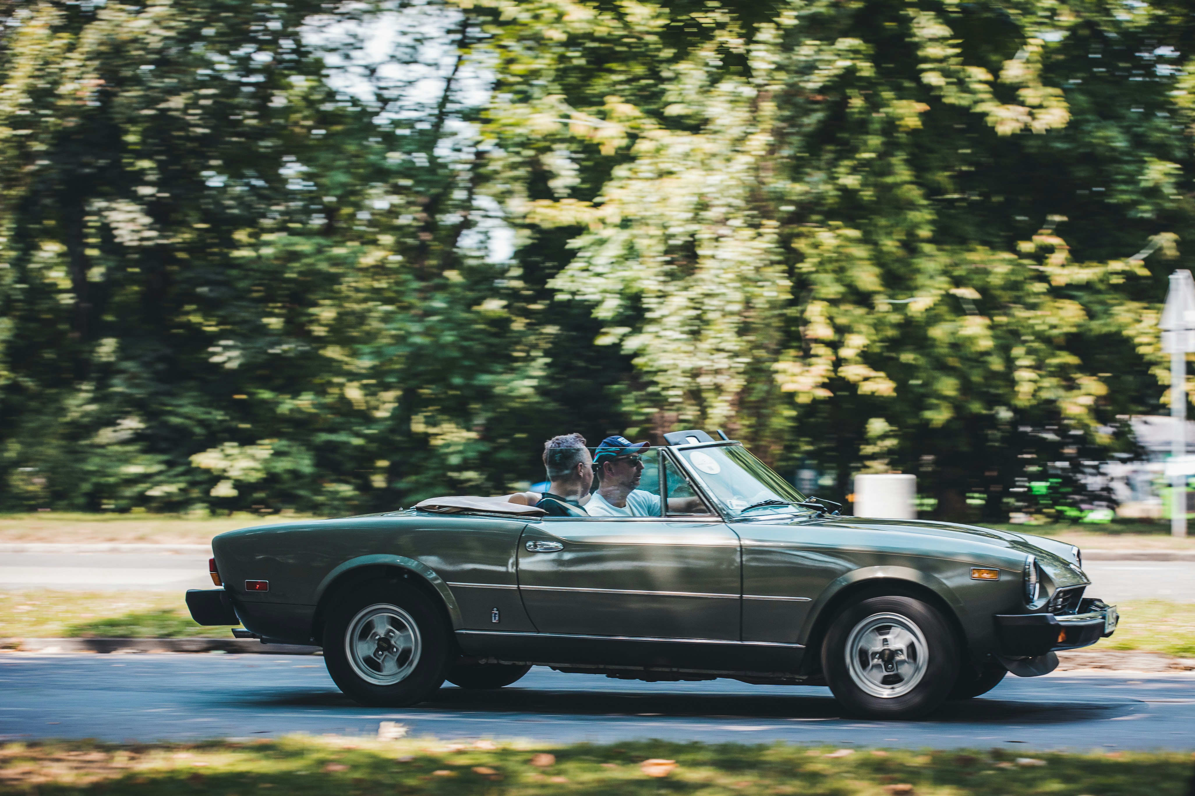 a couple of people riding in the back of a car