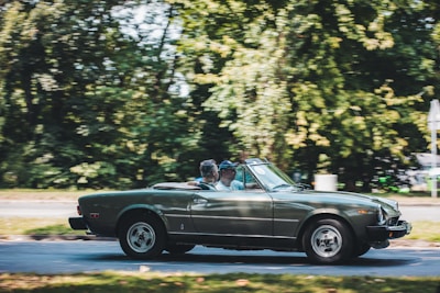 A peaceful scene of a couple driving a car, symbolizing covered journeys.
