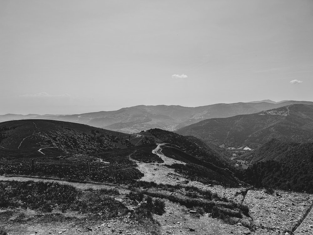 a black and white photo of a mountain road