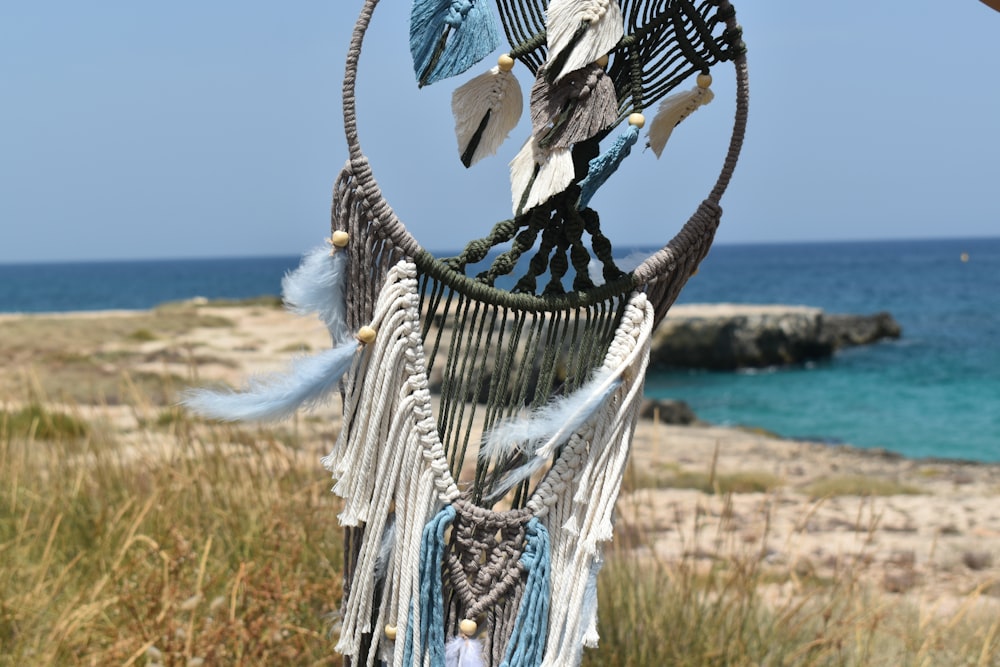 a close up of a wind chime near a body of water