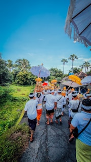Pilgrims in traditional attire walking along a peaceful pathway lined with marigold garlands.
