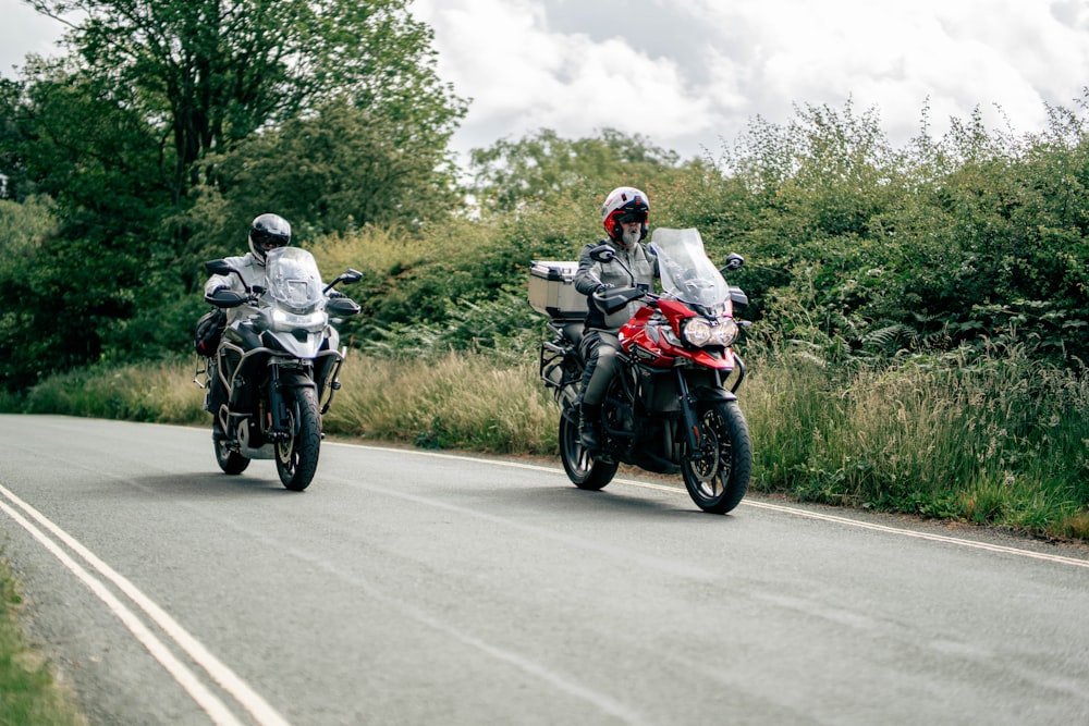 two motorcyclists riding down a country road