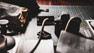 A camera capturing a detailed shot of a creative workspace.