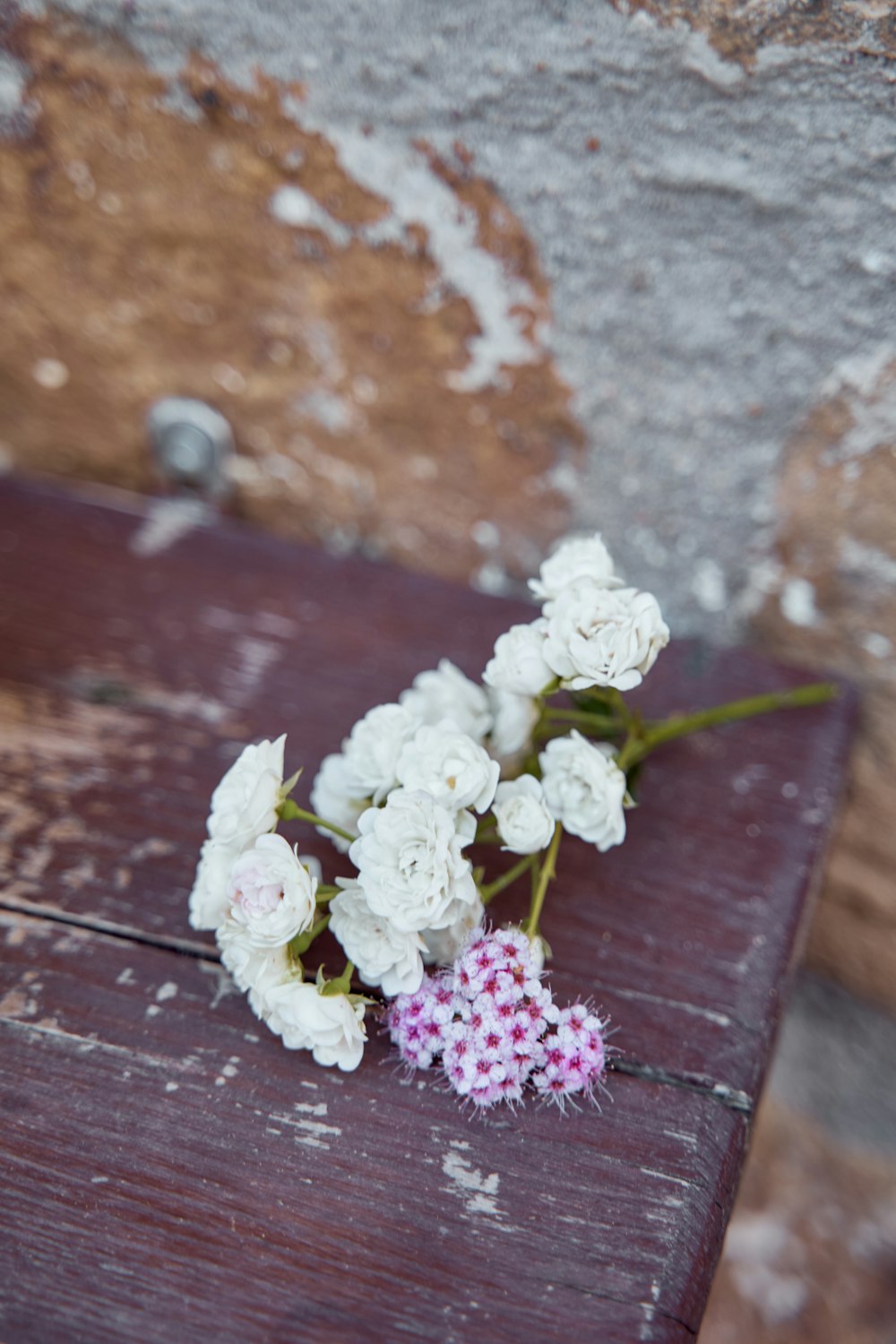 a bunch of white flowers sitting on top of a wooden table