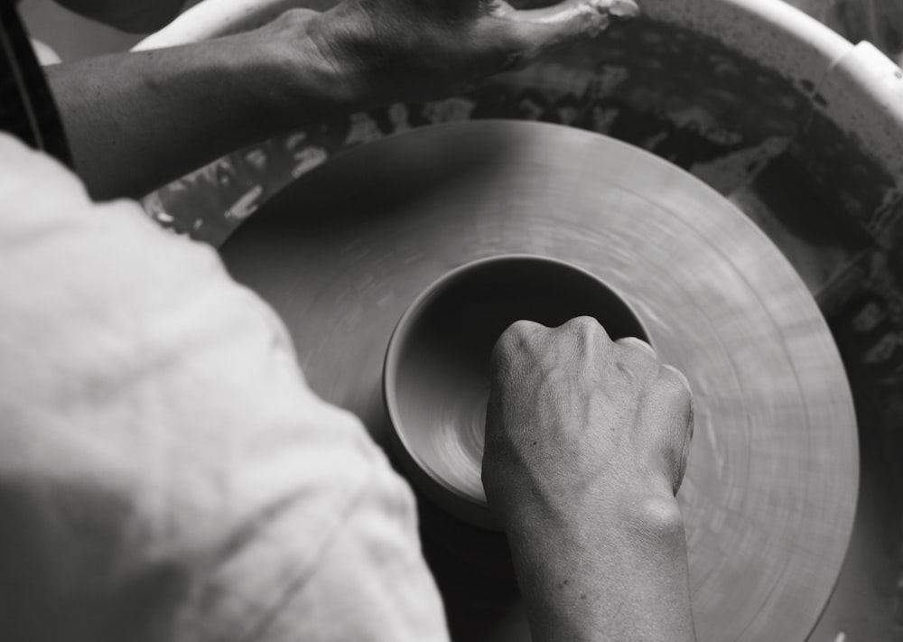 a person working with a wheel on a machine