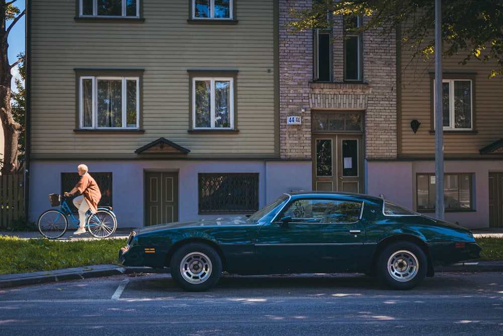 a man riding a bike next to a car