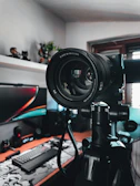 High-definition camera mounted on a tripod aimed at a podcasting desk.