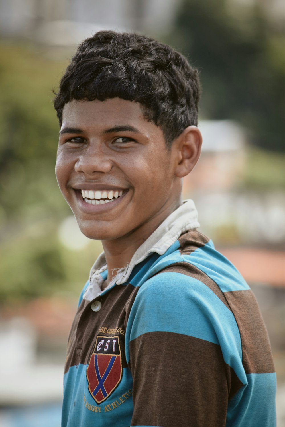a young boy smiling at the camera